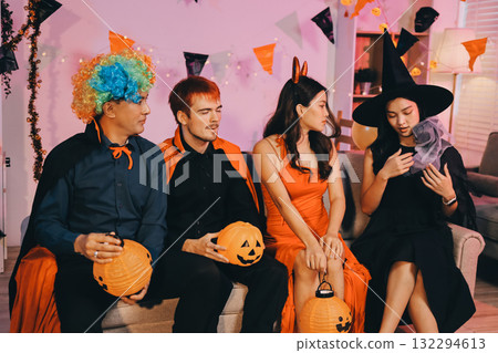Joyful office Halloween party with coworkers in costumes, celebrating with drinks and laughter, fostering teamwork and festive spirit 132294613
