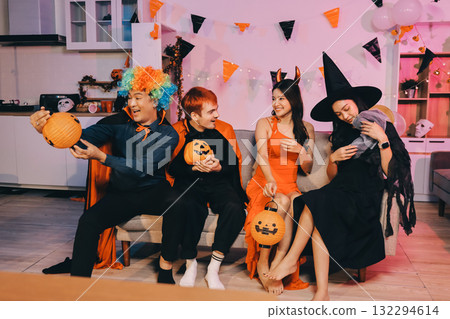 Joyful office Halloween party with coworkers in costumes, celebrating with drinks and laughter, fostering teamwork and festive spirit 132294614