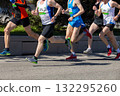 Five male athletes run marathon race down city street 132295260