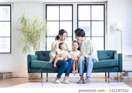 A young family relaxing in the living room A young family relaxing in the living room 132295502