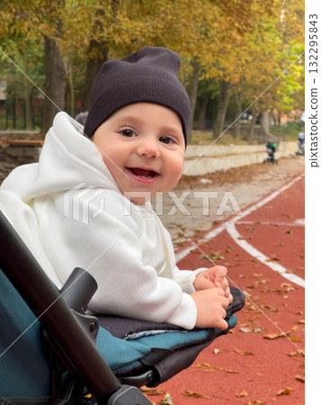 Baby in Hoodie on Track Field in Autumn Baby in Hoodie on Track Field in Autumn 132295843