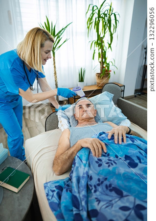 Nurse checks temperature of patient in cozy home setting Nurse checks temperature of patient in cozy home setting 132296056