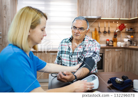 Health check with caring nurse at home setting Health check with caring nurse at home setting 132296078