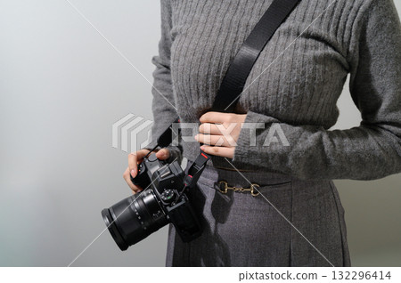A woman carrying a camera A woman carrying a camera 132296414