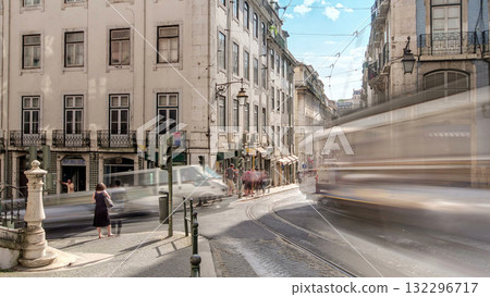 Famous tram 28 line in the center of Lisbon - yellow and blue tramways stop at the tram station timelapse 132296717