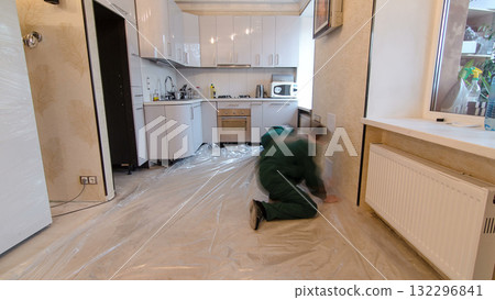 Carpenter worker installing substrate before wood parquet board during flooring work timelapse 132296841