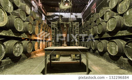 Barrels in the wine cellar with table and candle on it, Portugal timelapse 132296884