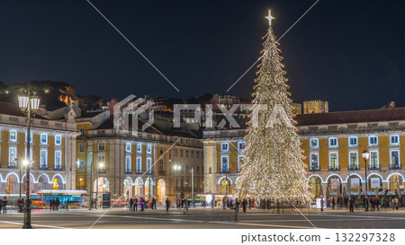 Commerce Square in Lisbon illuminated at Christmas hyperlapse, with a towering tree and crowds celebrating at night. Portugal 132297328