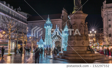 Night timelapse hyperlapse of Christmas decorations with illuminated castle on Luis de Camoes square in Lisbon, Portugal. 132297332