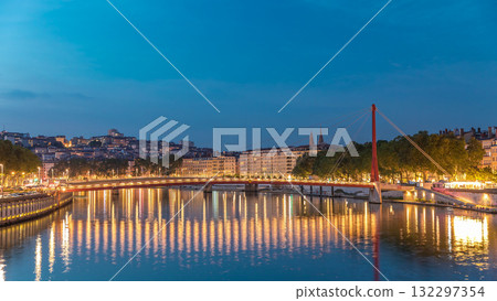 Hyperlapse of the Passerelle du Palais du Justice bridge over the Saone River in Lyon, transition from day to night timelapse. 132297354