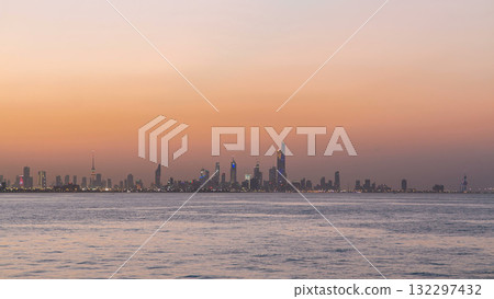 Skyline with Skyscrapers day to night timelapse in Kuwait City downtown illuminated at dusk. Kuwait City, Middle East 132297432