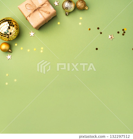 Christmas gift with ornaments on a green background Christmas gift with ornaments on a green background 132297512