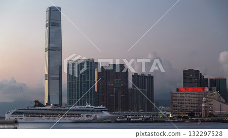 Hong Kong, China skyline panorama with skyscrapers from across Victoria Harbor evening timelapse. 132297528