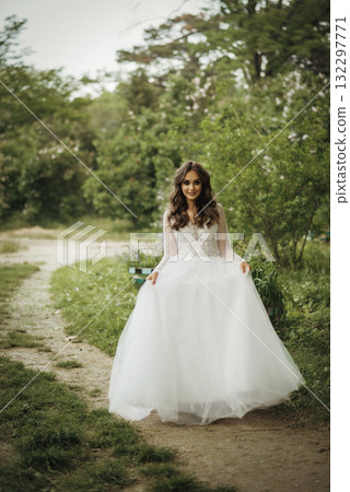 young beautiful girl bride in elegant wedding dress in park 132297771