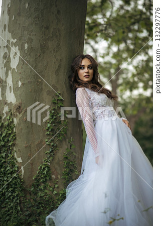 young beautiful girl bride in elegant wedding dress in park 132297776