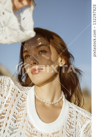 close-up of a beautiful young girl. she is looking at the sun 132297828