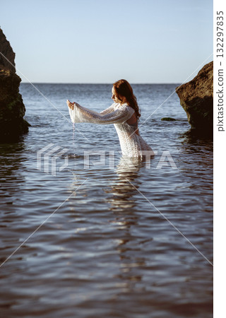beautiful young girl posing on sea beach, in water 132297835
