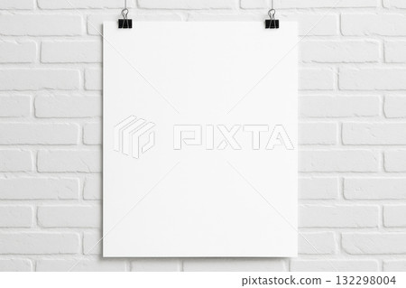 Blank white poster mockup hanging on white brick wall. Minimalist template on clean background, perfect for design or presentation, creating feeling of pure potential Blank white poster mockup hanging on white brick wall. Minimalist template on clean background, perfect for design or presentation, creating feeling of pure potential 132298004
