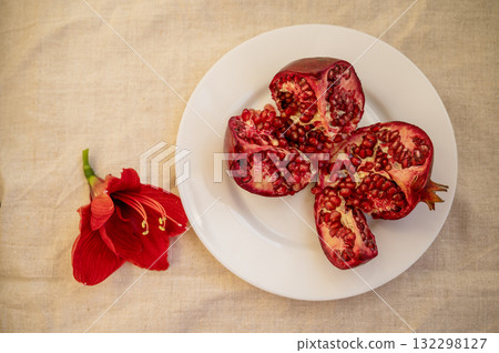 large red ripe pomegranate fruit and red flower large red ripe pomegranate fruit and red flower 132298127