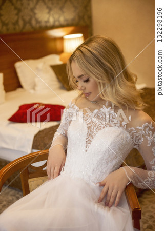 close up of beautiful blonde bride in wedding dress in hotel room 132298196