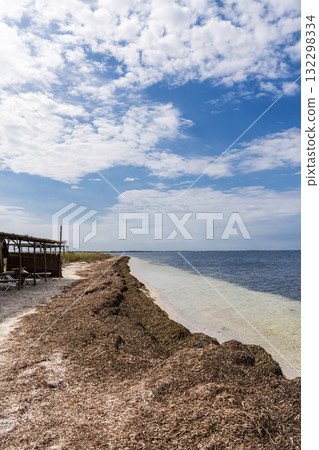 A sandy beach next to a body of water A sandy beach next to a body of water 132298334