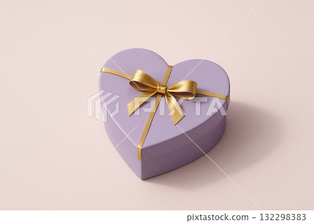 Heart shaped gift box with golden ribbon on pastel background, perfect for celebrations or special occasions. 132298383