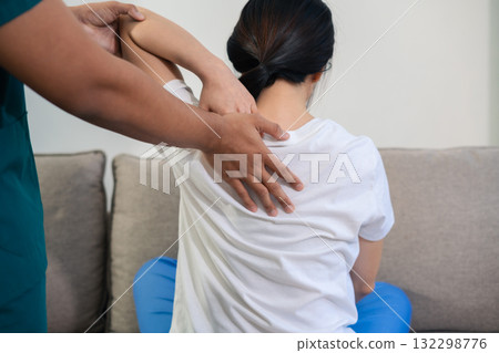 woman doing exercise at clinic with physiotherapist. help of a therapist trainer during a rehabilitation session. woman doing exercise at clinic with physiotherapist. help of a therapist trainer during a rehabilitation session. 132298776
