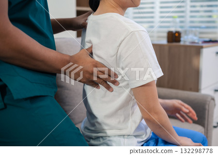 woman doing exercise at clinic with physiotherapist. help of a therapist trainer during a rehabilitation session. woman doing exercise at clinic with physiotherapist. help of a therapist trainer during a rehabilitation session. 132298778