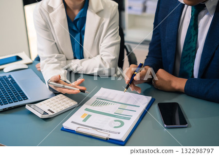 Business people discussing on performance revenue in meeting. financial adviser analyzing data with investor at office. 132298797