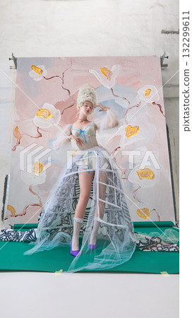 Rococo woman in corset posing confidently against artistic floral backdrop Rococo woman in corset posing confidently against artistic floral backdrop 132299611