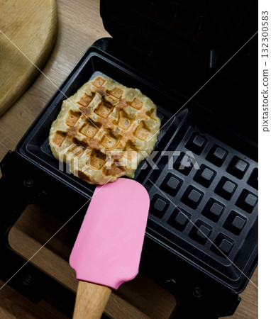 cooking homemade waffles cooking homemade waffles 132300583
