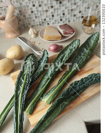 Kale leaves on wooden board at home. Healthy eating, farm produce. Kale leaves on wooden board at home. Healthy eating, farm produce. 132300810