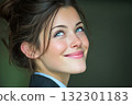 Woman with a warm smile and bright blue eyes radiates positivity in a simple indoor setting 132301183