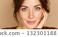 Woman with clear skin and bright eyes smiles gently creating a warm and inviting atmosphere 132301188
