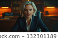 Professional woman with light hair sits at a desk exuding confidence in a well lit office environment 132301189