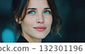 Woman with blue eyes and a warm smile showcases relaxed confidence in a serene and soft background 132301196