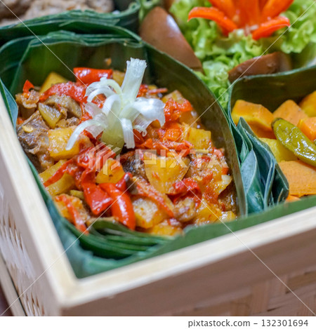 Sambal goreng kentang ati, Indonesian spicy potato and beef liver in chili sauce, served in banana leaf box Sambal goreng kentang ati, Indonesian spicy potato and beef liver in chili sauce, served in banana leaf box 132301694