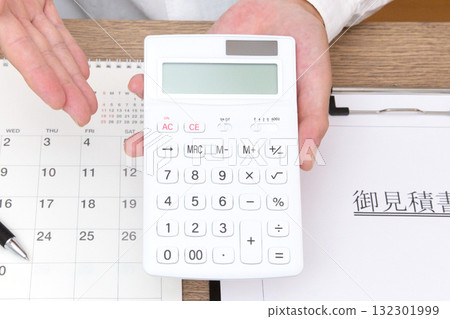 The hand of a person holding a calculator The hand of a person holding a calculator 132301999