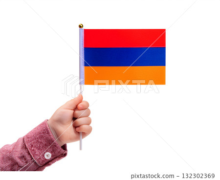 Child's hand holding a small Armenian flag. 132302369