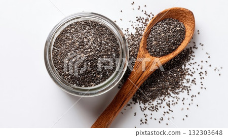 Chia seeds in glass jar and wooden spoon on white background. Healthy superfood ingredient rich in omega fatty acids and fiber for nutrition diet Chia seeds in glass jar and wooden spoon on white background. Healthy superfood ingredient rich in omega fatty acids and fiber for nutrition diet 132303648