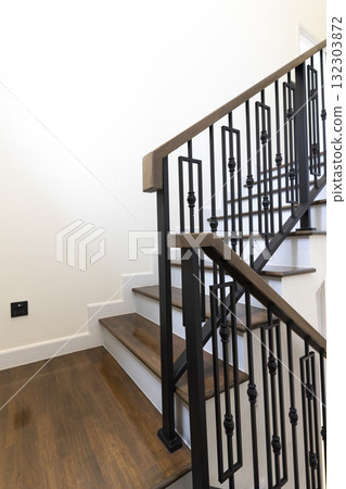 Modern stair case between floors. Stairs with metallic rail in modern building 132303872