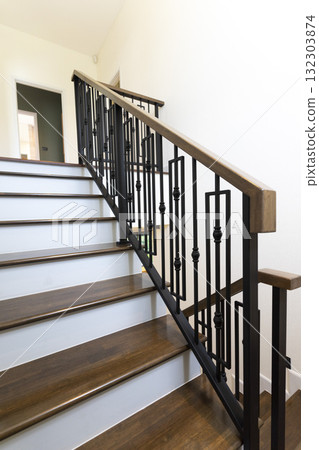 Modern stair case between floors. Stairs with metallic rail in modern building Modern stair case between floors. Stairs with metallic rail in modern building 132303874