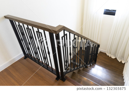 Modern stair case between floors. Stairs with metallic rail in modern building Modern stair case between floors. Stairs with metallic rail in modern building 132303875