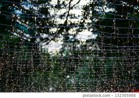 Close-up of the outdoor starry solar string lights. Festive decoration. For background use. Close-up of the outdoor starry solar string lights. Festive decoration. For background use. 132305008