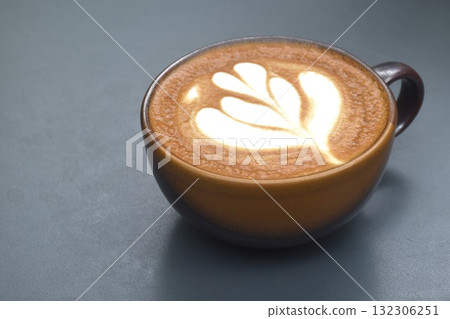 hot cappuccino coffee with latte art in cup on table hot cappuccino coffee with latte art in cup on table 132306251