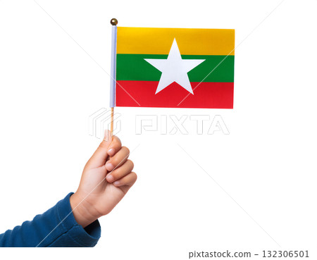A child's hand holds a small Myanmar flag. 132306501