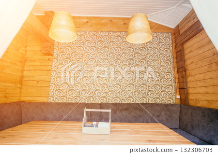 Cozy Wooden Interior with Patterned Wall and Hanging Lamps Cozy Wooden Interior with Patterned Wall and Hanging Lamps 132306703