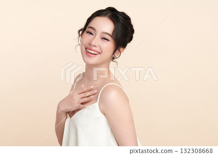 A beautiful young Asian woman with clean, fresh skin against a beige background. Skincare, facial treatment, cosmetology, beauty, and spa. An elegant portrait of an Asian woman. A beautiful young Asian woman with clean, fresh skin against a beige background. Skincare, facial treatment, cosmetology, beauty, and spa. An elegant portrait of an Asian woman. 132308668