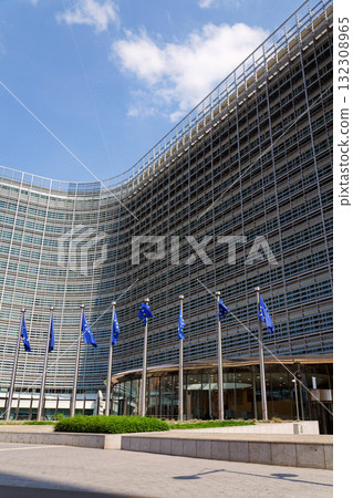 Waving EU flags in front of the Berlaymont building headquarters of the European Commission in Brussels, Belgium 132308965