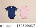 Two Onesie. Blue and pink baby clothes on beige pastel background. Fashion newborn clothes. Flat lay, top view. Baby kids clothing set. Infant cotton bodysuit. Gender. Baby shower concept. Boy or Girl 132309037